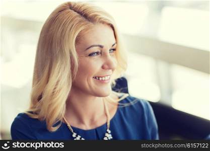 people, women and lifestyle concept - happy smiling blonde woman in blue clothes