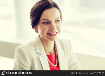people, women, business and lifestyle concept - happy elegant young woman in jacket at office