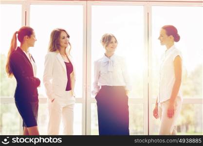 people, work and corporate concept - business women meeting at office and talking. business women meeting at office and talking