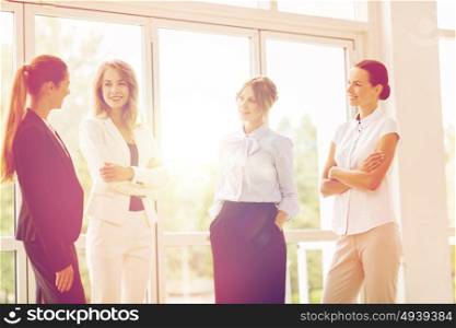 people, work and corporate concept - business women meeting at office and talking. business women meeting at office and talking