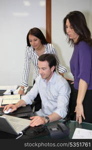 People working around a computer