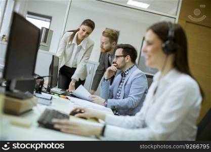 People working in a busy office as a teamwork concept