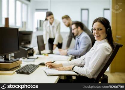 People working in a busy office as a teamwork concept