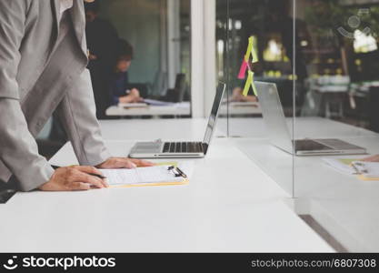 people working with document and laptop computer for use as office workplace concept