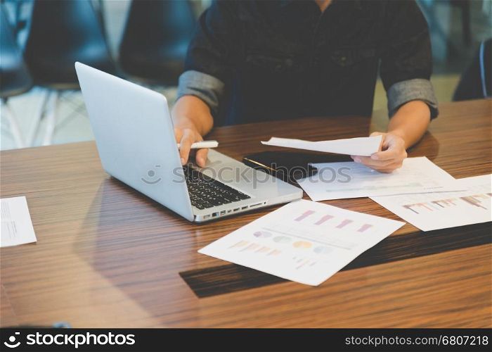 people working with document and laptop computer in office workplace - blur for background