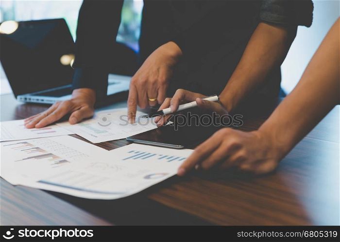 people working with document, tablet and laptop computer - meeting in office workplace concept
