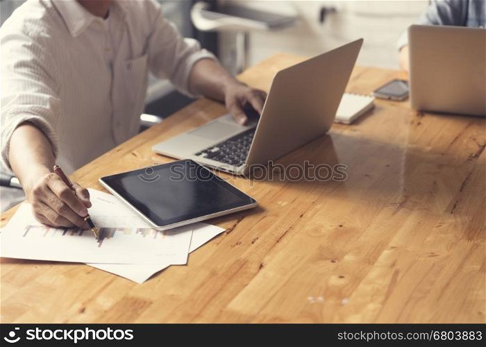 people working with laptop computer notebook and business document, selective focus and vintage tone