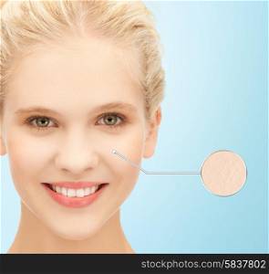 people, youth, skincare and beauty concept - face of beautiful happy teenage girl over blue background