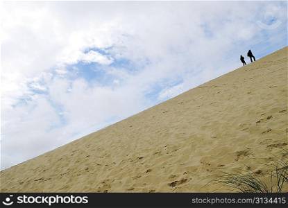 peoples walking along dunes