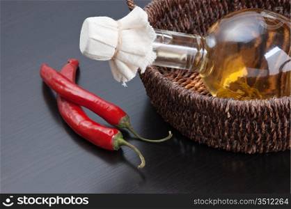 pepper and a bottle of vegetable oil in a basket