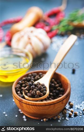 pepper in bowl and on a table