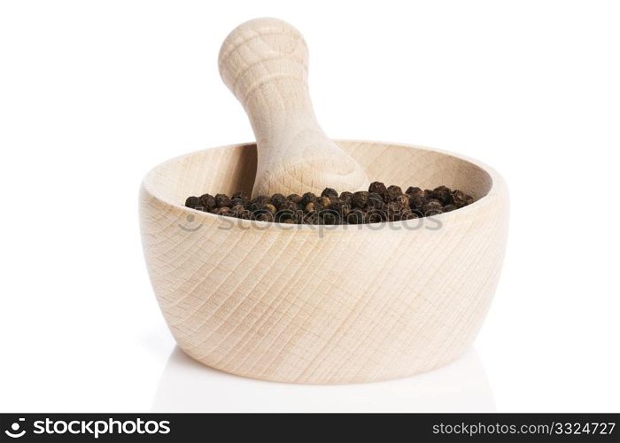 peppercorns in a wooden mortar. peppercorns in a wooden mortar on white background