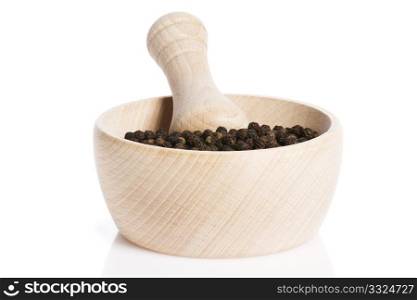 peppercorns in a wooden mortar. peppercorns in a wooden mortar on white background