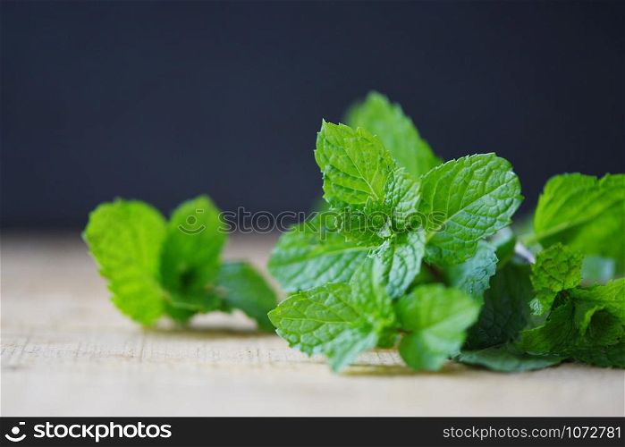 Peppermint leaf on wood / Fresh mint leaves on dark background