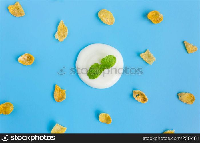 Peppermint on Yogurt with Cornflakes on Blue Pastel Background Minimalist Style. Cereal Breakfast healthy clean food for food and dessert category