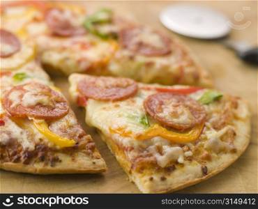 Pepperoni and Pepper Pizza with a Pizza Cutter