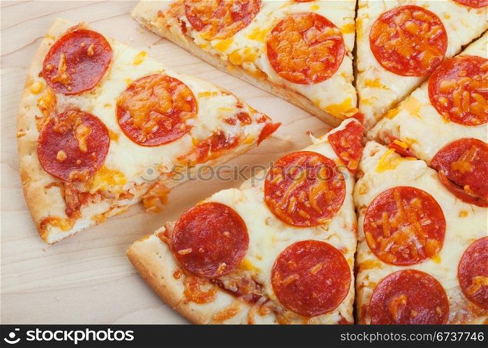 Pepperoni pizza closeup on wood ready to serve