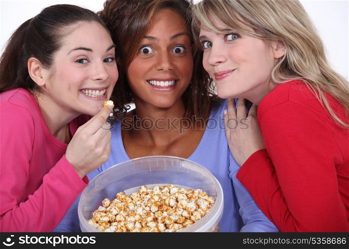 Peppy women eating popcorn