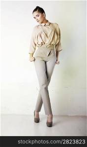 Perfect fashionable lady wearing white trousers and blouse