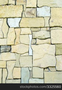 Perfect Fit Stone wall with odd shaped natural stones in light brown and beige