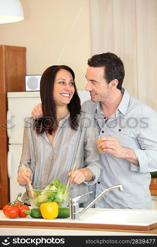 perfect housewife preparing meal with husband by her side