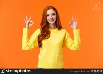 Perfect idea concept, acception. Good-looking redhead girl in yellow sweater, showing okay, good or approval sign smiling nod agreement, satisfied with result, all perfect, orange background.. Perfect idea concept, acception. Good-looking redhead girl in yellow sweater, showing okay, good or approval sign smiling nod agreement, satisfied with result, all perfect, orange background
