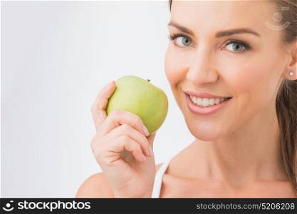 Perfect woman with apple. Beautiful young nude woman with green apple close up on white background