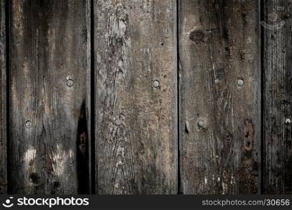 Perfectly lit wooden background with weathered wood and ruusty nails