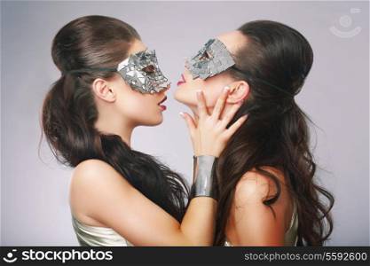 Performance. Fancy Women in Surrealistic Stylized Silver Masks