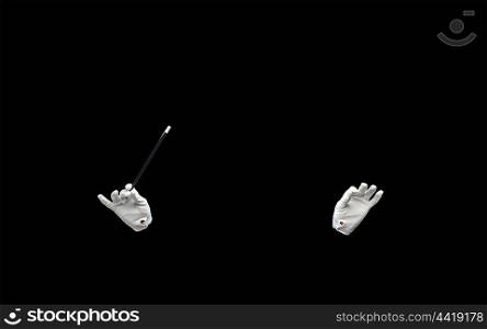 performance, illusion, circus, show concept - magician hands in gloves with magic wand showing trick over black background