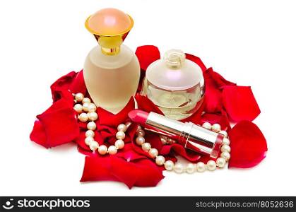 Perfume and pearl necklace in rose petals isolated on white.