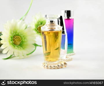 perfume assortment with pearl and flowers