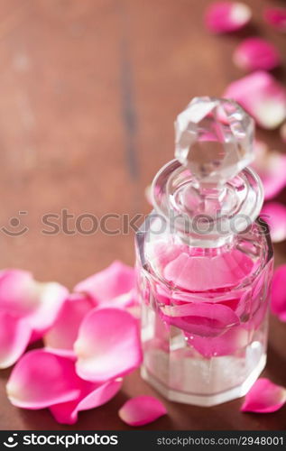 perfume bottle and pink rose flowers. spa aromatherapy