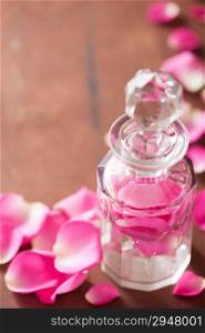 perfume bottle and pink rose flowers. spa aromatherapy