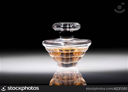 Perfume in a stylish glass jar on abstract background
