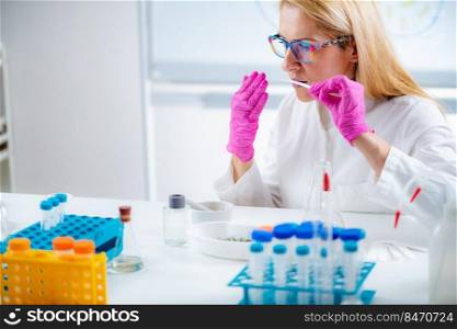 Perfumer, testing, aromatic, oil, smelling, test, paper, fragrance, perfume, lab, aromacology, laboratory, analysis, aroma, expert, research, science, component, examine, olfactory, tube, flask, sensory, measure, olfactory system, formulation, aerosol, chemical, chemistry, substance, receptors, woman, female, hands, protective, gloves, biochemical, biotechnology, biology,  . Perfumer Testing Aromatic Oil. Smelling from Test Paper.