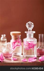perfumery and aromatherapy set with rose flowers and flasks
