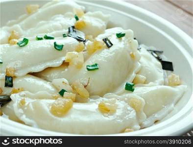 perogi - dumplings of unleavened dough ? first boiled, which various toppings.traditionally stuffed with potato filling, sauerkraut, ground meat, cheese, or fruit. Of Central and Eastern European.