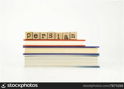 persian word on wood stamps stack on books, foreign language and translation concept