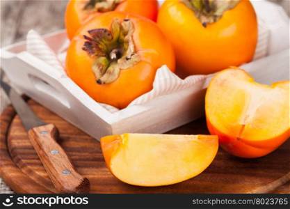 persimmon. persimmons on wooden background