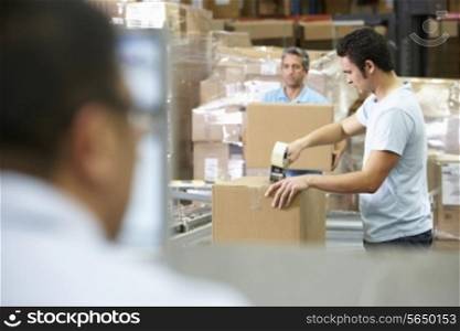 Person At Computer Terminal In Distribution Warehouse