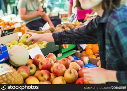 person buying fruits vegetables