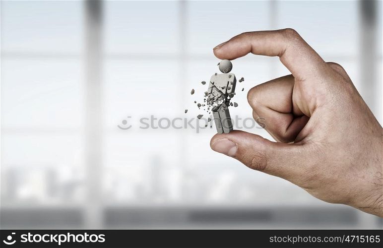Person figure between fingers. Close view of male hand taking with fingers male figure