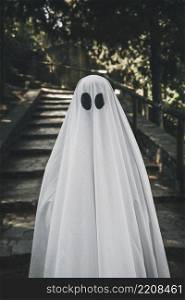 person ghost costume standing forest