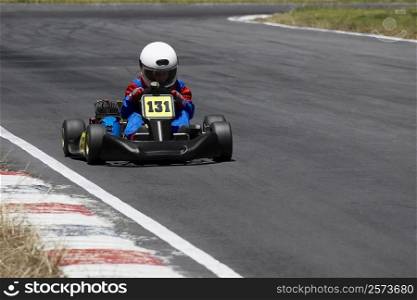 Person go-carting on a motor racing track