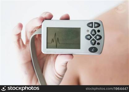 person hand holding monitor with cardiogram. High resolution photo. person hand holding monitor with cardiogram. High quality photo