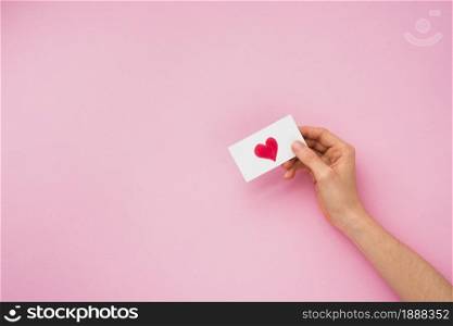 person hand holding paper with heart picture . Resolution and high quality beautiful photo. person hand holding paper with heart picture . High quality and resolution beautiful photo concept