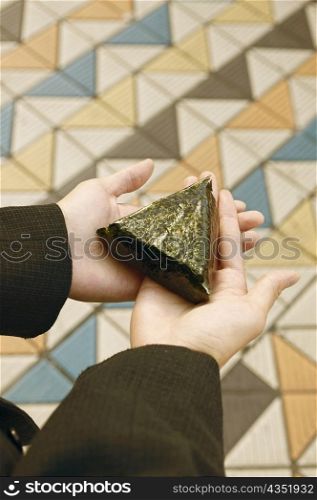 Person holding a triangular shaped leaf