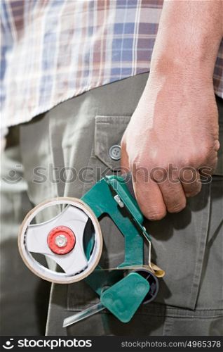 Person holding adhesive tape