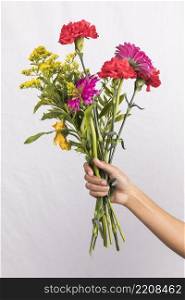 person holding big flowers bouquet